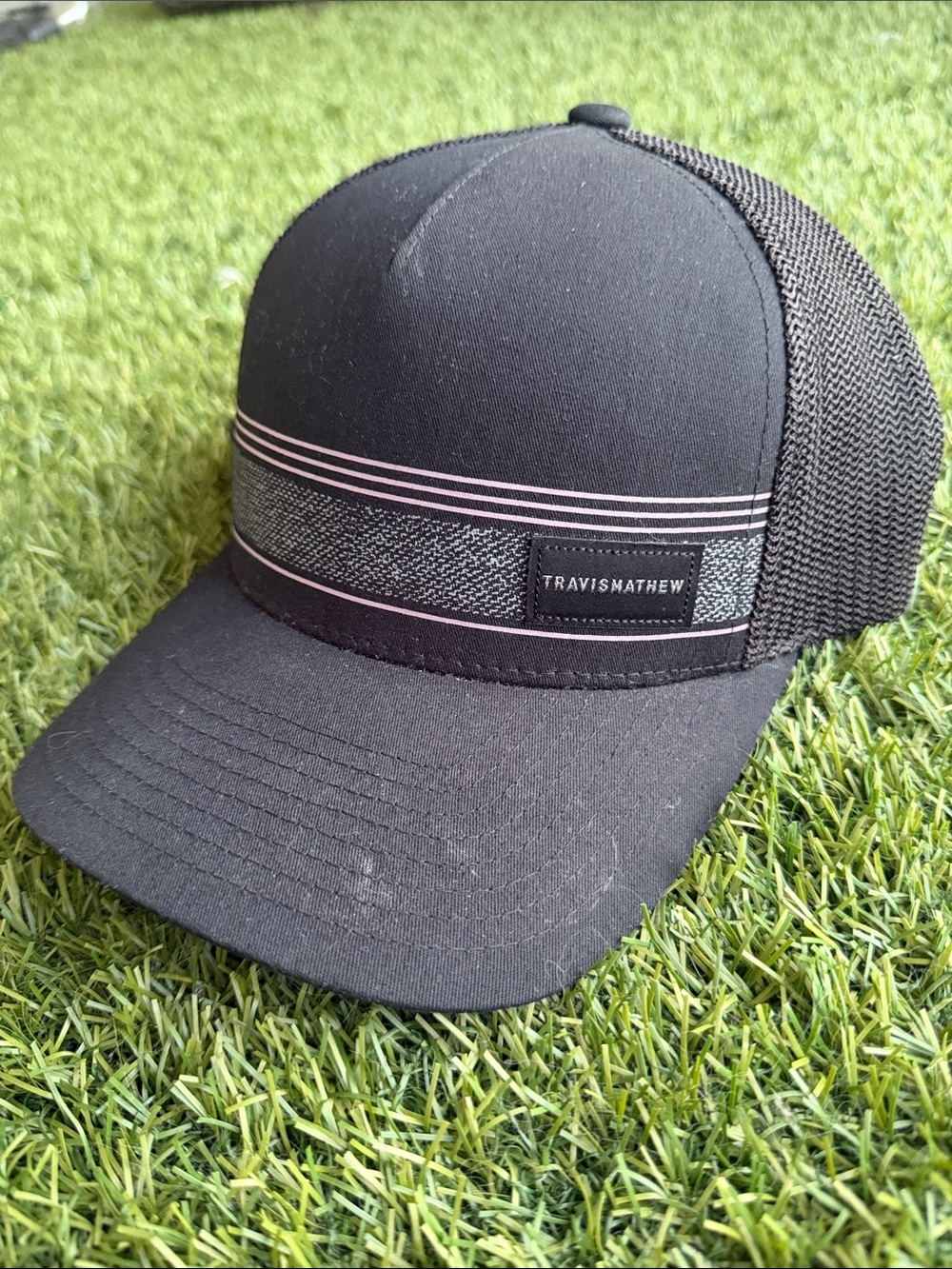 TravisMathew Black Trucker Hat with Pink Stripe